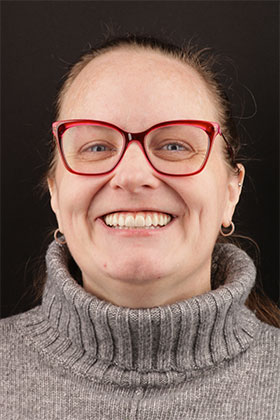 Restored smile with implant-supported bridges, showing a perfect alignment.